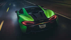 綠色McLaren跑車在夜間潮濕道路上疾馳，尾燈閃爍。