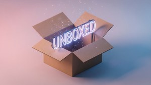一個紙箱打開，露出一個發光的霓虹燈牌，上面寫著 unboxed，並伴有閃爍的粒子。