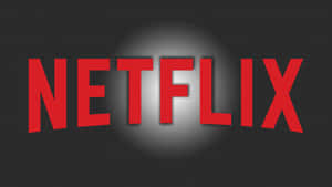 在深色背景上被聚光燈照亮的紅色Netflix標誌。