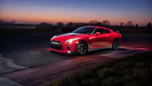 暮色中賽道上可見星星的紅色日產GT-R