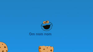 Cookie Monster 微笑著，旁邊有朱古力曲奇，藍色背景上寫著「Om nom nom」。