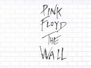 用黑色馬克筆在白色瓷磚牆上寫的Pink Floyd The Wall。