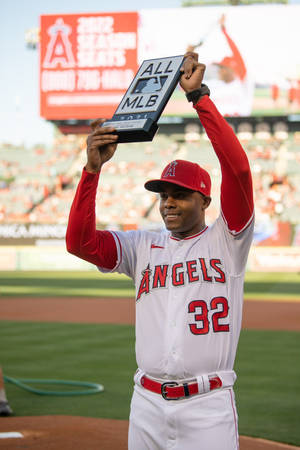 棒球選手在棒球場上高舉All MLB獎盃。