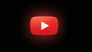 深色背景上帶有發光紅色播放按鈕的 YouTube 標誌