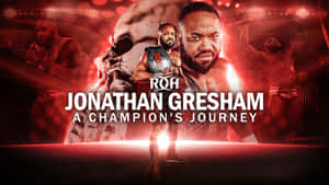 摔角手 Jonathan Gresham 在紅色競技場燈光下手持冠軍腰帶。