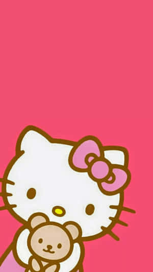 Hello Kitty 在粉紅色背景上抱著一隻泰迪熊。