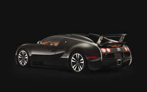 黑色Bugatti Veyron跑車，帶有後翼和發光尾燈，背景為黑色。 — MacBook Pro M1 壁紙