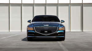 藍色Genesis G80豪華轎車停在一棟現代建築前。 — 酷車 壁紙
