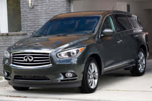 深灰色 Infiniti QX60 SUV 停泊在磚屋前。 — 酷車 壁紙