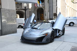 銀色McLaren跑車，鷗翼車門打開，停泊在城市行人路上。 — MacBook Air M2 壁紙