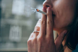 人在室內窗邊吸煙