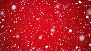 雪花落在紅色背景上，用於節日慶祝