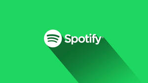 綠色背景上帶有長陰影的Spotify標誌。