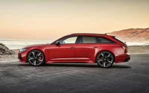 紅色Audi RS6 Avant旅行車在日落時停泊在海邊。 — 2880x1800 壁紙