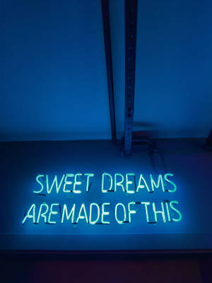 藍光中寫著 sweet dreams are made of this 的霓虹燈牌。