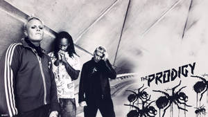 三位 The Prodigy 的音樂人在一個有螞蟻塗鴉和樂隊名稱的隧道中。 — 音樂 GIF 壁紙