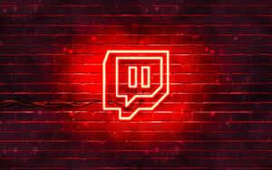夜晚潮濕磚牆上的紅色霓虹燈Twitch標誌。