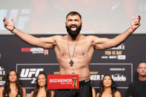 UFC拳手在稱重活動中舉起雙臂慶祝勝利。
