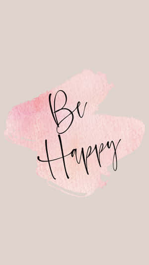 Be Happy 勵志名言以黑色草書寫在粉紅色水彩背景上。