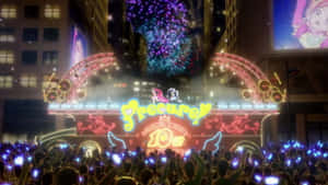 動畫巡遊花車，帶有發光燈光和夜間歡呼的人群。 — Vocaloid 壁紙