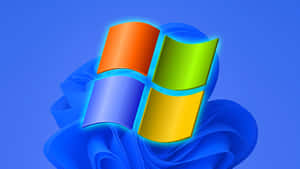 Windows標誌，彩色面板漂浮在藍色布料漩渦上方。