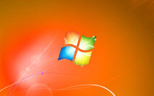 Windows 標誌帶有彩色面板，背景為發光的橙色。 — 橙色美學 壁紙