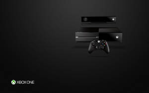 深色紋理背景上的Xbox One主機和控制器