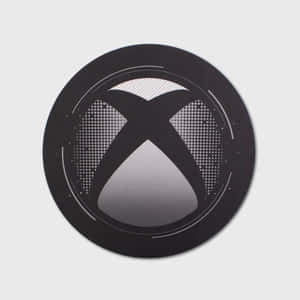 淺灰色背景上帶有漸變和點狀圖案的黑色 Xbox 標誌。