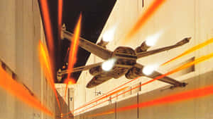 星際戰機在夜間建築物之間的峽谷中躲避激光攻擊。 — 星際大戰 壁紙