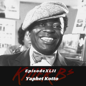 Yaphet Kotto 戴著平頂帽和領結微笑，帶有文字疊加。