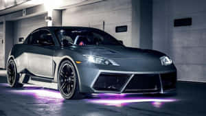 光滑的啞光灰色跑車，帶有紫色底盤燈，在混凝土車庫中。 — Audi R8 GIF 壁紙