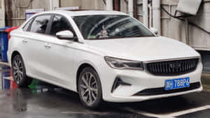 白色現代轎車停泊在濕漉漉的市區街道上，帶有倒影。 — 酷車 壁紙