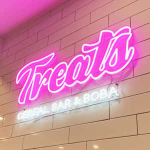瓷磚牆上為 Treats Cereal Bar & Boba 設置的粉紅色霓虹燈招牌。 — 霓虹城市 壁紙
