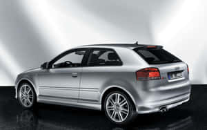 銀色奧迪A3 Sportback，帶有紅色尾燈和合金輪圈，在光亮的黑色地板上。 — Steam Deck OLED 壁紙