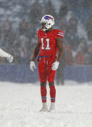 身穿紅色球衣的美式足球員站在球場的雪中 — NFL 美式足球 GIF 壁紙