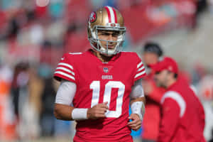 三藩市四九人四分衛身穿10號在足球場上行走 — NFL 美式足球 GIF 壁紙