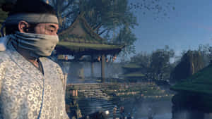 一位身穿長袍的男子站在寺廟前 — 對馬戰鬼 GIF 壁紙
