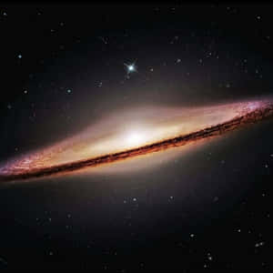 一個擁有發光旋臂和明亮恆星的螺旋星系。 — 可愛星系 壁紙