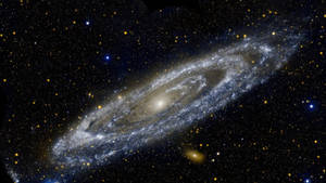 一個在深空中帶有明亮旋臂和散落恆星的螺旋星系。 — 太空 壁紙