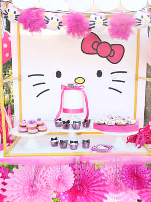 Hello Kitty主題派對甜品桌，配有粉紅色裝飾和美食。 — Kindle 壁紙