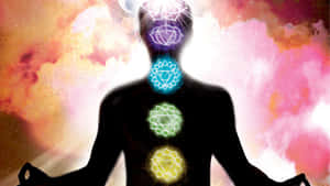 一個人在色彩繽紛的宇宙背景下冥想，帶有發光的脈輪。 — 靈性動態圖 壁紙
