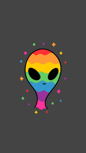 一個微笑的彩虹外星人，帶有閃光，背景為深灰色。 — 外星人 壁紙