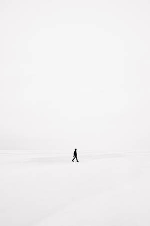 一個人獨自走過廣闊的雪地。 — 黑白 壁紙