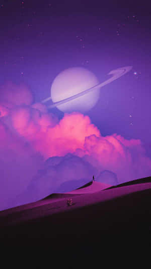一個人在沙丘上，紫色天空下有環狀行星 — Astroworld GIF 壁紙