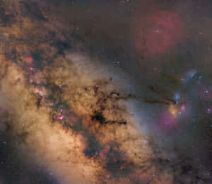 深空中充滿活力的宇宙星雲，帶有粉紅色和橙色的雲團以及散落的星星。 — Astroworld GIF 壁紙