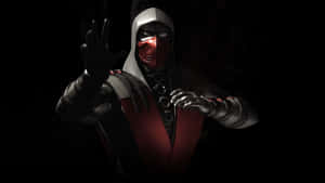 身穿紅黑盔甲的Mortal Kombat角色在黑暗環境中舉起手。 — 戰士 壁紙