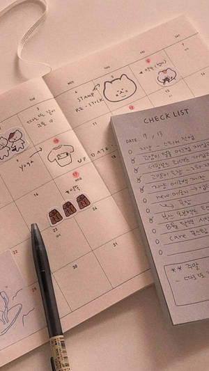 手繪日曆，帶有可愛塗鴉和筆旁的檢查清單。 — 書籍 壁紙