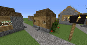 Minecraft村莊，有木屋和石屋、鵝卵石小徑和火把。 — 型格 Minecraft 壁紙