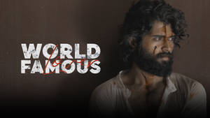男人臉上和襯衫上有血，旁邊是黑暗牆壁上的「WORLD FAMOUS」文字。 — 電影 壁紙