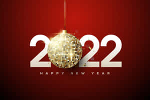 金色 disco 波懸浮在 2022 年上方，紅色背景上帶有 'Happy New Year' 文字。 — MacBook Air M3 壁紙